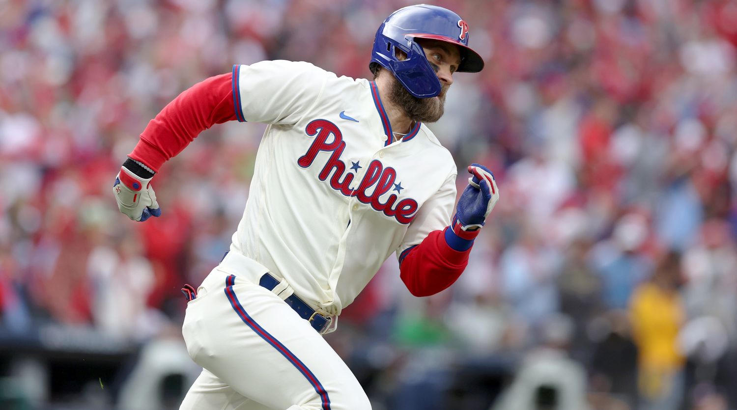 Bryce Harper runs to first base after hitting a single